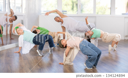 Preteen girl performing hip hop in group class for kids Preteen girl performing hip hop in group class for kids 134124894
