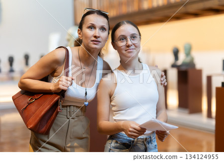Woman and teenage girl looking at sculpture hall 134124955