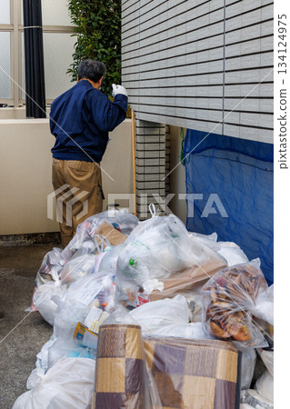 Trash in an apartment complex and the person who sorts it out Trash in an apartment complex and the person who sorts it out 134124975