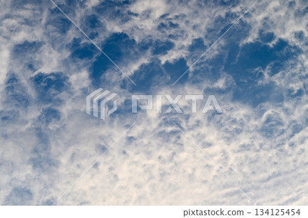 Dramatic and Mesmerizing Cloud Patterns Formed in a Stunningly Beautiful Blue Sky Above the Horizon Dramatic and Mesmerizing Cloud Patterns Formed in a Stunningly Beautiful Blue Sky Above the Horizon 134125454