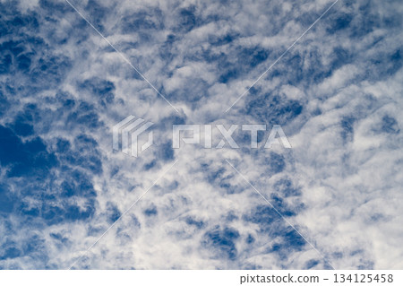 Captivating Dynamic Cloud Patterns Forming Beautifully Against a Bright Blue Sky Captivating Dynamic Cloud Patterns Forming Beautifully Against a Bright Blue Sky 134125458