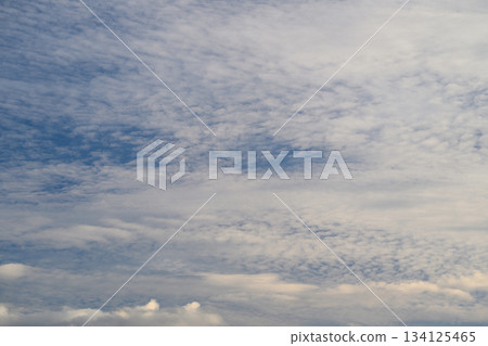 A clear afternoon with a beautiful blue sky and soft, fluffy clouds floating above A clear afternoon with a beautiful blue sky and soft, fluffy clouds floating above 134125465