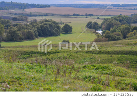 A Serene Landscape Featuring Beautiful Rolling Hills and Lush Greenery All Around A Serene Landscape Featuring Beautiful Rolling Hills and Lush Greenery All Around 134125553