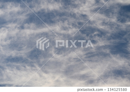 Stunning and Beautiful Cloud Patterns Gracefully Displayed Against a Clear Blue Sky 134125580