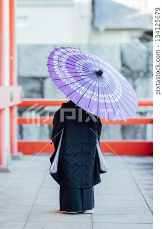 Shichi-Go-San: Back view of a boy holding a Japanese umbrella Shichi-Go-San: Back view of a boy holding a Japanese umbrella 134125679