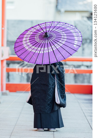 Shichi-Go-San: Back view of a boy holding a Japanese umbrella Shichi-Go-San: Back view of a boy holding a Japanese umbrella 134125680