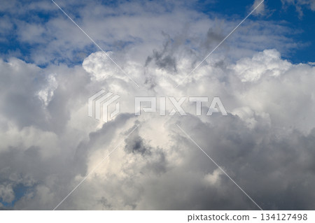 A Dramatic and Striking Cloud Formation Alongside a Bright Blue Sky Positioned Over Us A Dramatic and Striking Cloud Formation Alongside a Bright Blue Sky Positioned Over Us 134127498