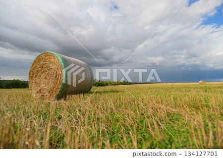A Lonely Hay Bale Sitting Below a Dramatic Sky in a Beautiful Rural Landscape Setting A Lonely Hay Bale Sitting Below a Dramatic Sky in a Beautiful Rural Landscape Setting 134127701