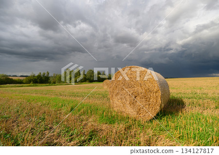 A Rustic Hay Bale Set Against a Dramatic and Stunning Sky, Filled with Wonder and Beauty A Rustic Hay Bale Set Against a Dramatic and Stunning Sky, Filled with Wonder and Beauty 134127817
