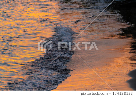 The beach bordering on the sunset 134128152