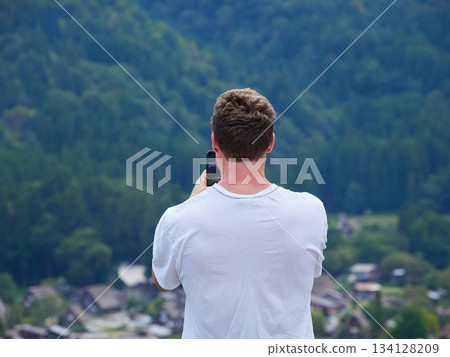 Foreign tourists looking at the scenery from the observation deck of Shirakawa-go, a World Heritage Site 134128209