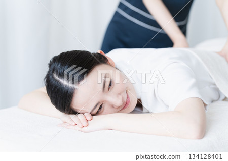 Young woman receiving massage from therapist Beauty image Young woman receiving massage from therapist Beauty image 134128401