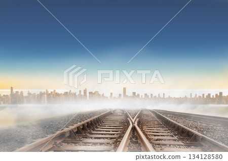 Railway tracks leading to city on the horizon Railway tracks leading to city on the horizon 134128580