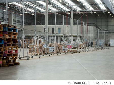 Flat design warehouse is showing mobile wire mesh fencing rolling on concrete floor under skylights 134128603