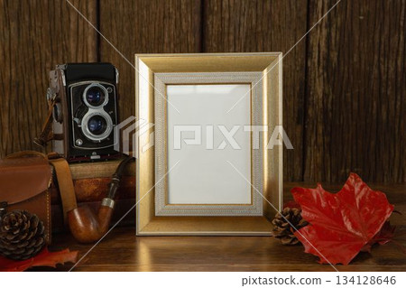 Photo frame and camera on table Photo frame and camera on table 134128646