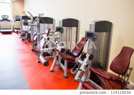 Exercise machines arranged in gym Exercise machines arranged in gym 134128836