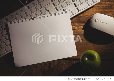 Book on keyboard with mouse and apple on table Book on keyboard with mouse and apple on table 134128986