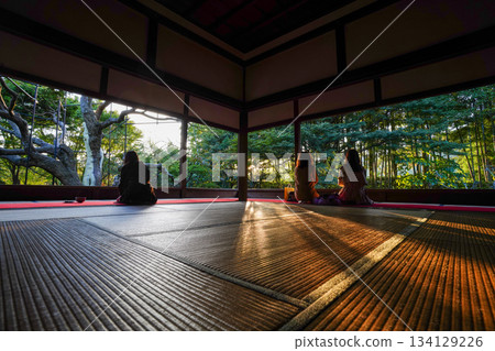 Back view of people sitting on the stool and looking at the garden at Hosen-in Temple in Ohara, Kyoto Back view of people sitting on the stool and looking at the garden at Hosen-in Temple in Ohara, Kyoto 134129226