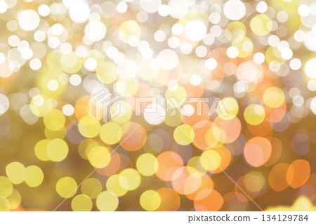 Bokeh light circles are creating glowing abstract background in flat design, blending warm tones Bokeh light circles are creating glowing abstract background in flat design, blending warm tones 134129784