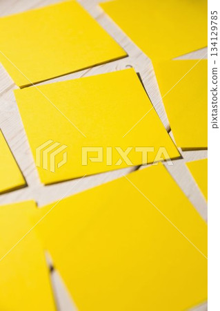 Yellow papers fallen on wooden floor 134129785