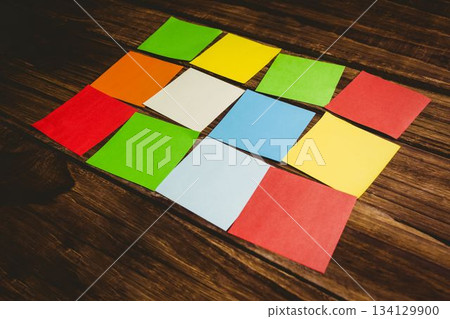 Multi colored papers on wooden floor Multi colored papers on wooden floor 134129900