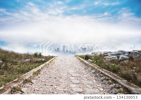 Stony path leading to misty cityscape Stony path leading to misty cityscape 134130053
