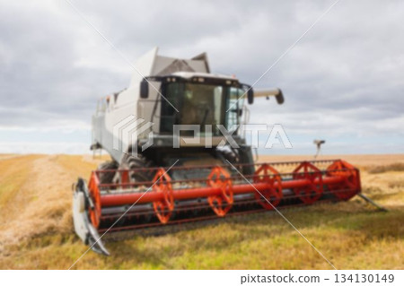 Combine harvester on sunny field Combine harvester on sunny field 134130149