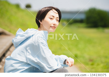 Young woman checking her sports watch. Sports image. Young woman checking her sports watch. Sports image. 134130375