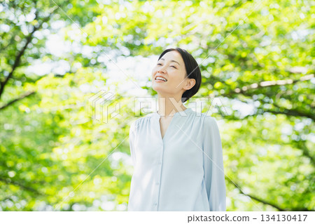 A young woman looking up at the tree-lined street Lifestyle image 134130417