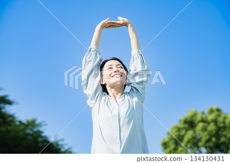 Young woman stretching outdoors Lifestyle image 134130431