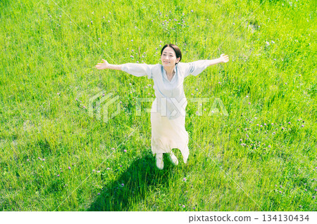 Young woman stretching in the grassland Lifestyle image Young woman stretching in the grassland Lifestyle image 134130434