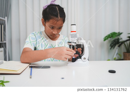 Elementary student adjusting microscope during hands on science activity for classroom learning Elementary student adjusting microscope during hands on science activity for classroom learning 134131762