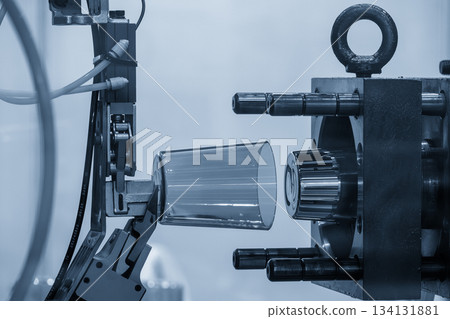 The plastic parts production process from injection mold machine in the light blue scene. 134131881