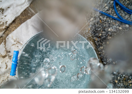 Hand washing in a bucket Hand washing in a bucket 134132099