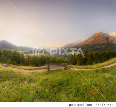Meadow with road and bench during sunset in Berchtesgaden National Park Meadow with road and bench during sunset in Berchtesgaden National Park 134132638