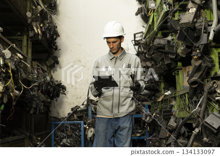 Technician worker working and checking in garage scrap yard car workshop warehouse. Technician worker working and checking in garage scrap yard car workshop warehouse. 134133097
