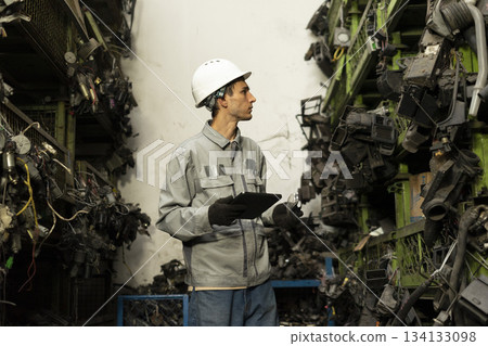 Technician worker working and checking in garage scrap yard car workshop warehouse. 134133098