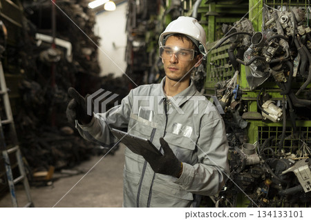 Technician worker working and checking in garage scrap yard car workshop warehouse. Technician worker working and checking in garage scrap yard car workshop warehouse. 134133101