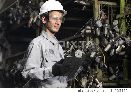 Technician worker working and checking in garage scrap yard car workshop warehouse. Technician worker working and checking in garage scrap yard car workshop warehouse. 134133111