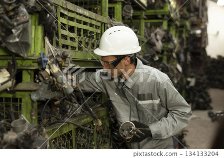 Technician worker working and checking in garage scrap yard car workshop warehouse. 134133204