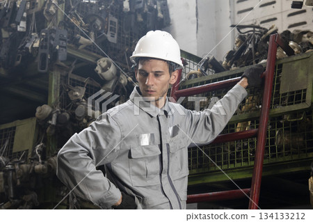 Technician worker working and checking in garage scrap yard car workshop warehouse. Technician worker working and checking in garage scrap yard car workshop warehouse. 134133212