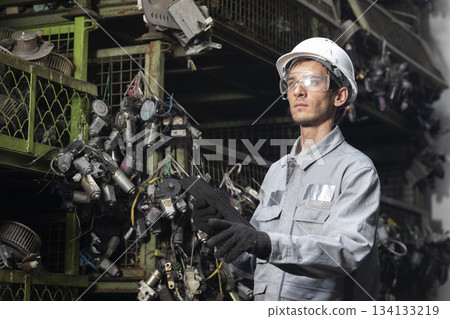 Technician worker working and checking in garage scrap yard car workshop warehouse. 134133219