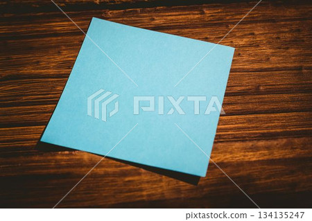 Blue paper on wooden flooring 134135247