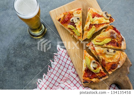 Pizza slices with beer glass on table 134135458