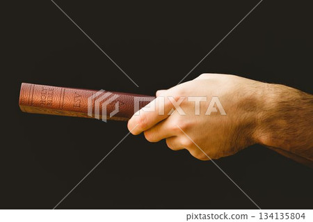 Close-up of hand holding Bible Close-up of hand holding Bible 134135804