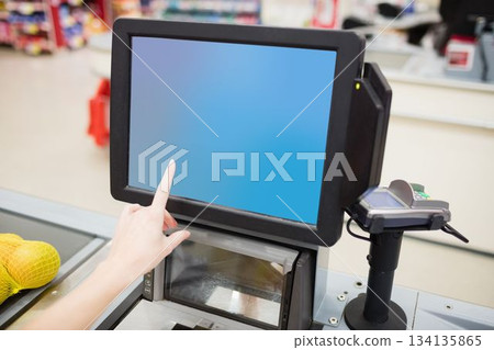 Cropped image of person touching barcode reader screen 134135865