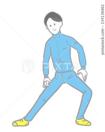 A young man in a blue jersey doing flexibility exercises 134136862