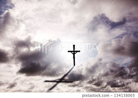 vector art showing silhouetted crucifix with Jesus standing against bright sky, casting shadow vector art showing silhouetted crucifix with Jesus standing against bright sky, casting shadow 134138003