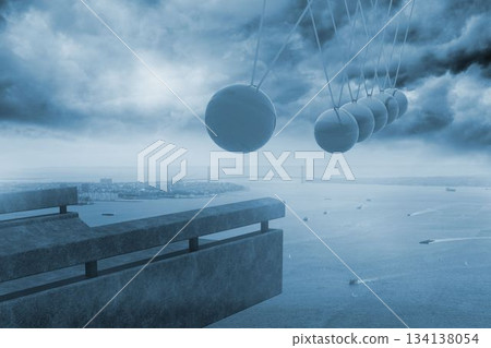 Newtons cradle above coastline Newtons cradle above coastline 134138054