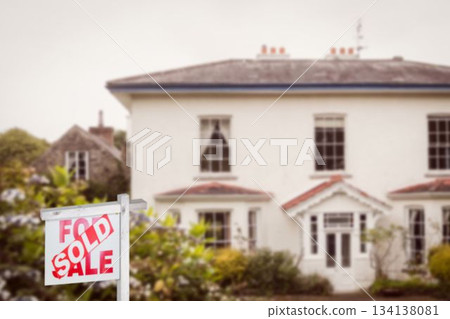 Real estate signboard in front of house exterior 134138081